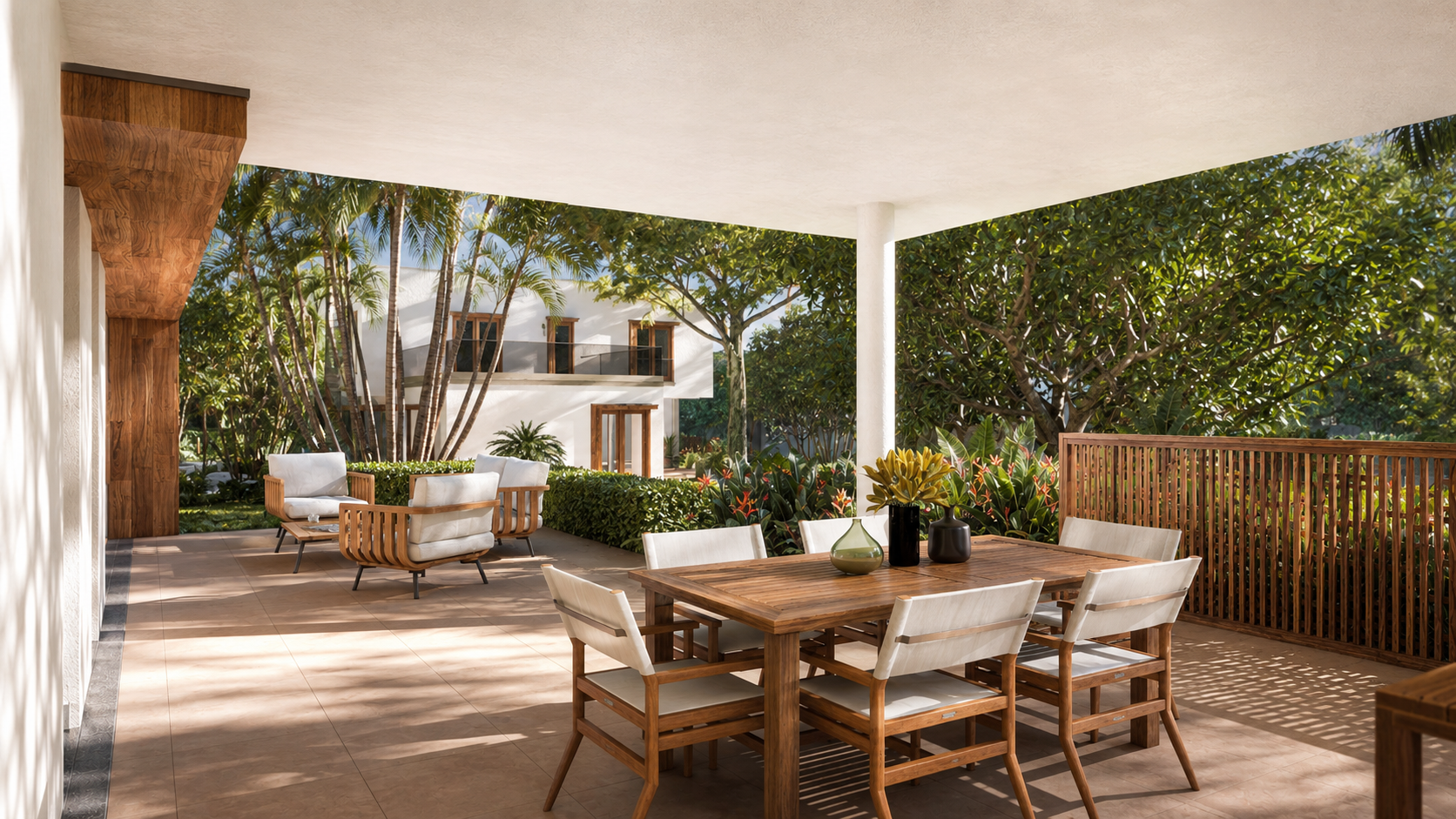 Living room in daylight: leather armchairs on solid timber frames, round nesting tables, dining area and open kitchen beyond, a full-width glazed door onto the covered terrace at the left