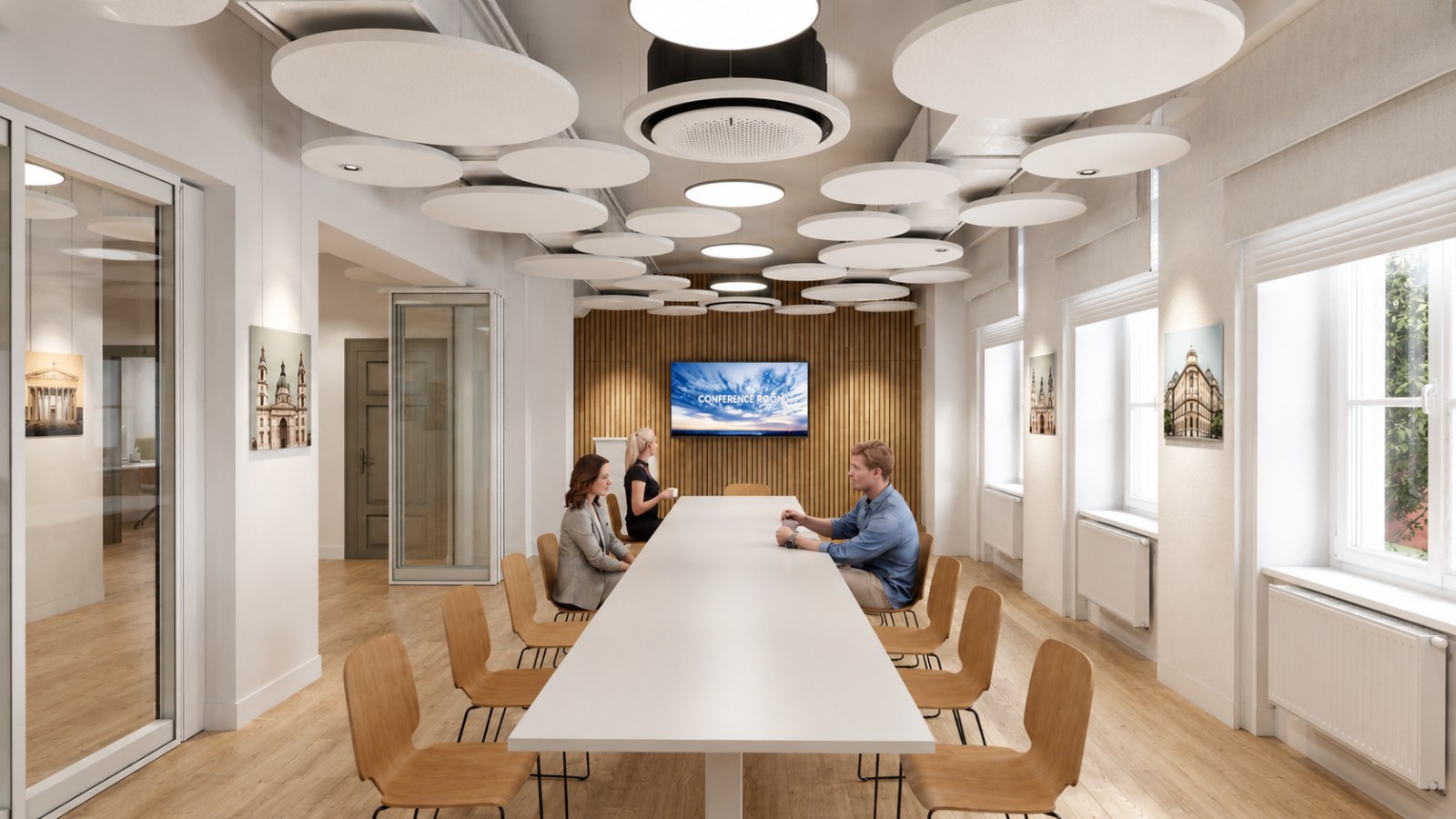 Meeting room in the Gdańsk loft office: a long white table, oak chairs, a slatted timber wall with a screen, circular acoustic panels floating below the soffit