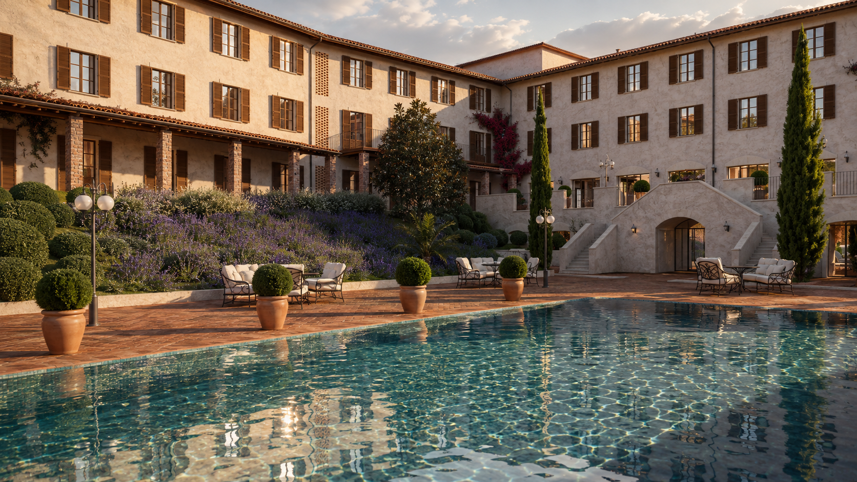 Courtyard pool in front of the three-storey wings, lavender beds and clipped shrubs on the slope