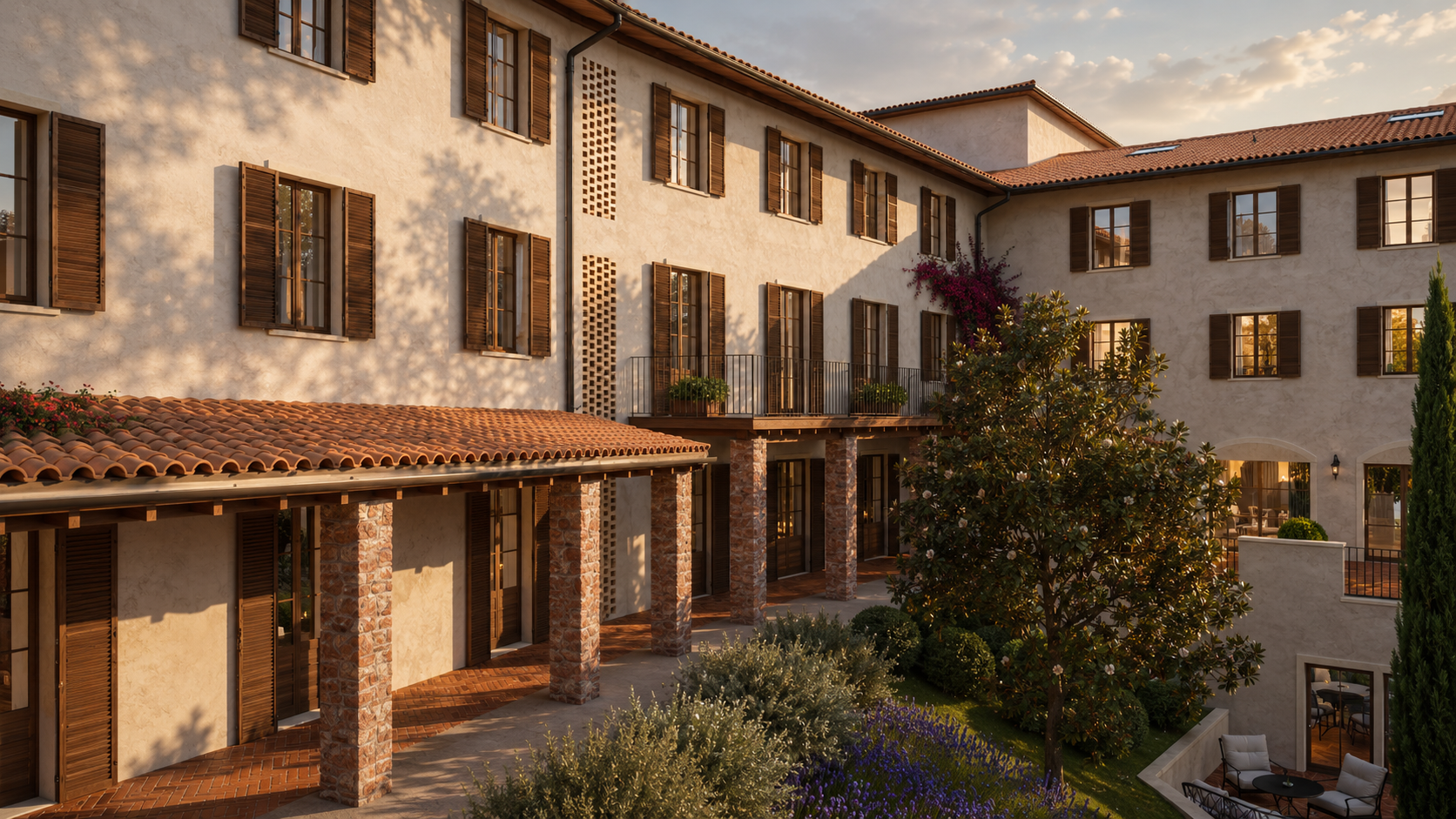 Ground-floor loggia with brick piers and timber shutters facing planted beds in evening light